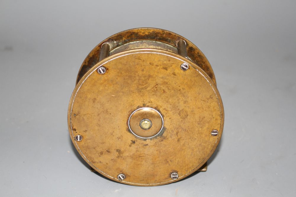 An early brass 4.5in. fishing reel by Army & Navy Cooperative Stores Ltd., engraved mark, diameter 11.5in., with horn handle